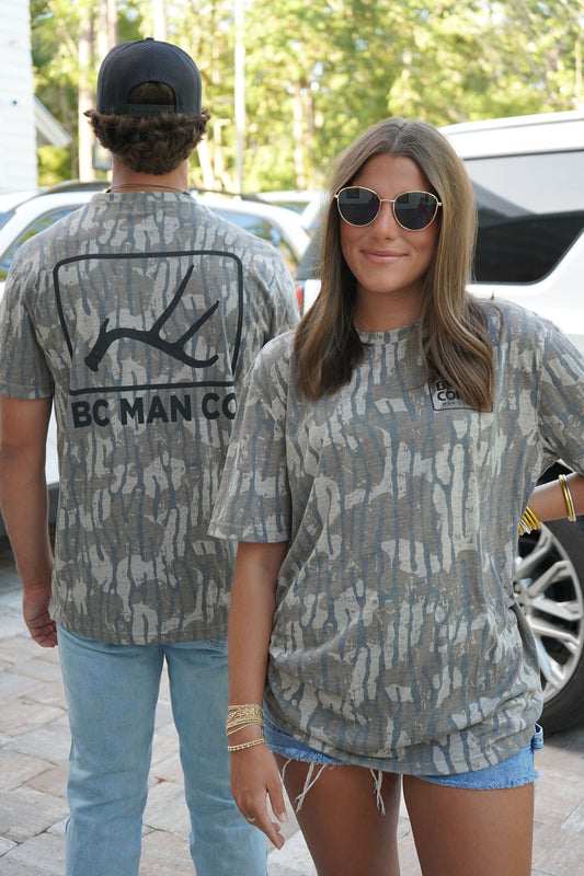 Man and woman wearing matching BC Man Co Timber Vintage Camo Tee oversized unisex camo t-shirts