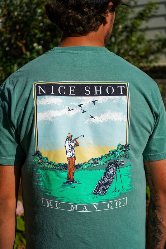 Man wearing the BC Man Co Nice Shot Tee in sage green, a funny golf and duck hunting t-shirt with full-color back print